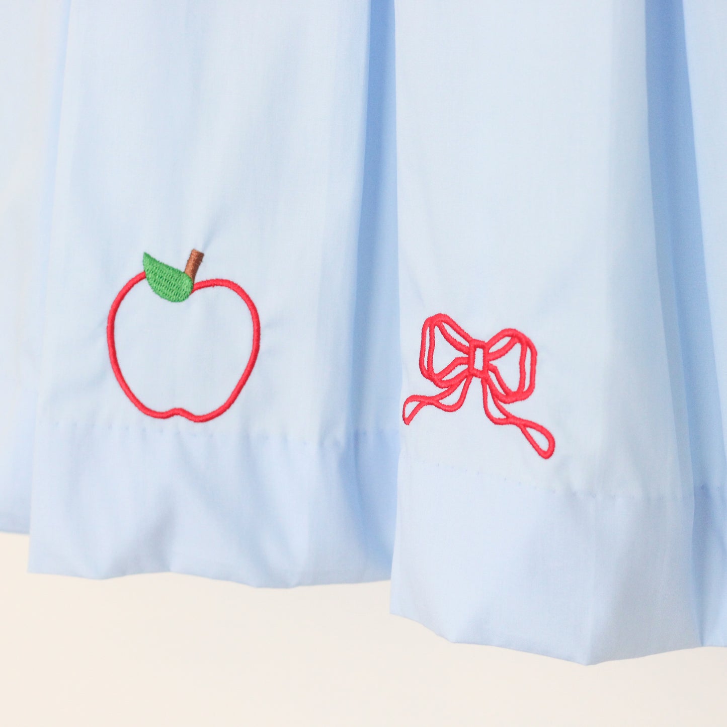 EMBROIDERED APPLE & BOW PLEATED DRESS